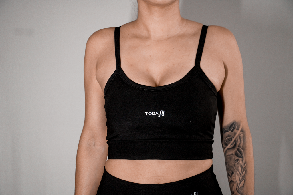 Detalhe do top slim preto TodaFit em close, ressaltando textura e qualidade.